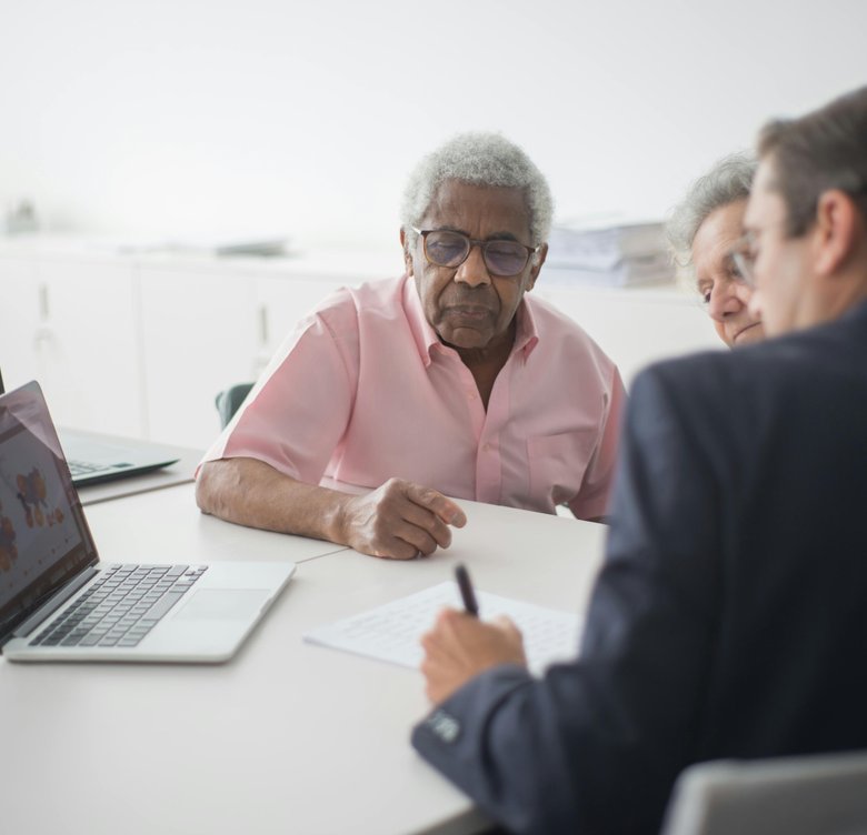 Adult child and senior parent reviewing coverage options together